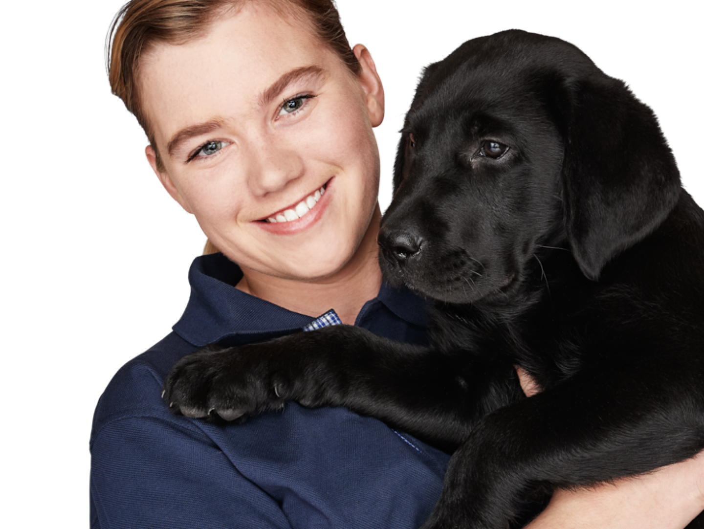 Vision Australia staff member holds a seeing eye dog puppy in her arms