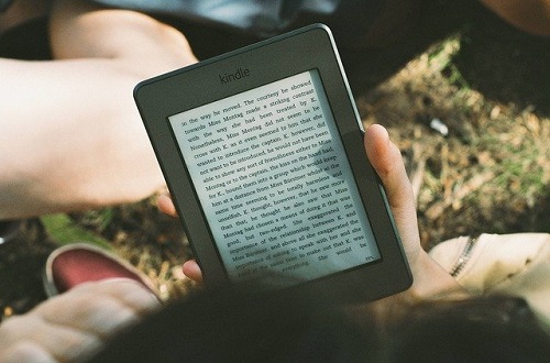 An ereader held in an outstretched hand