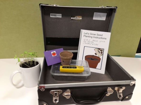 Let's Grow Seed Pack: a suitcase with instruction booklet, soil mix, seedling pot, seeds and audio player